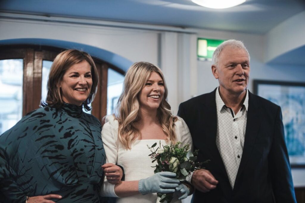 Group photo with bride, groom, and wedding guests outdoors in Ireland.