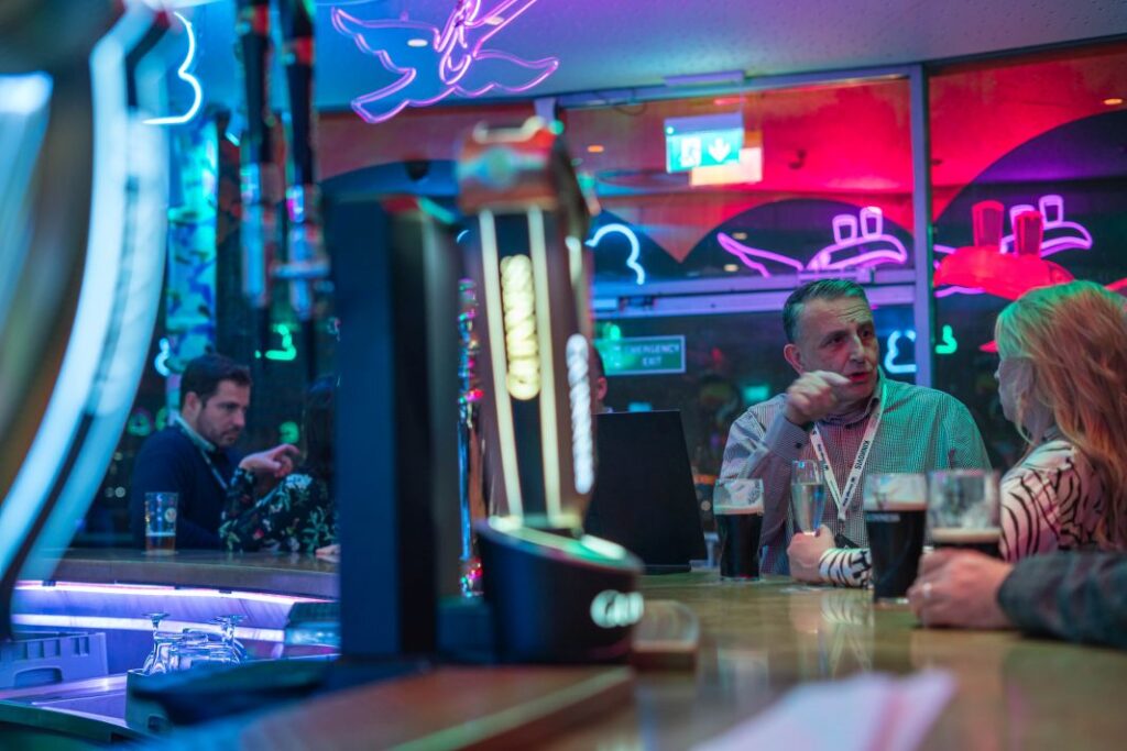 Attendees Enjoying Atmosphere Under Night Lighting - E17