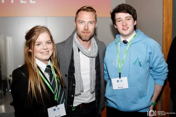Ronan Keating speaking on stage at a corporate conference in Dublin