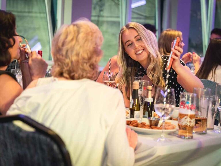 Guests sharing a laugh at the dinner table during a birthday party in Dublin