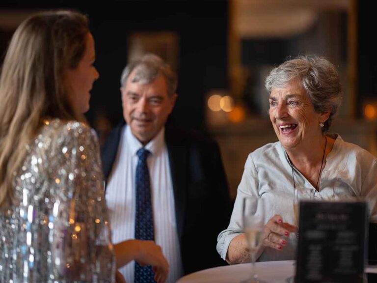 Older guests laughing together at a family celebration in Dublin