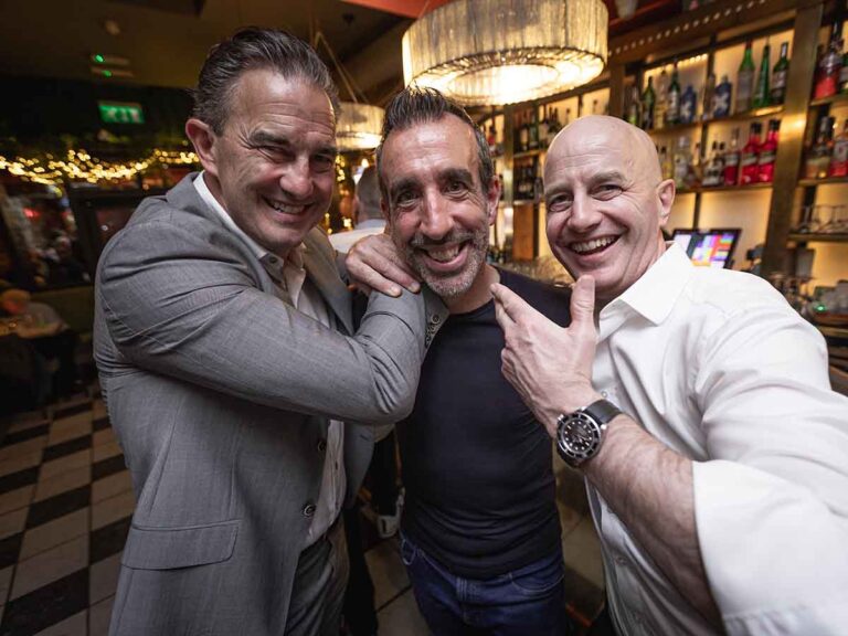 Three friends posing for a fun photo at a private party in a Dublin bar