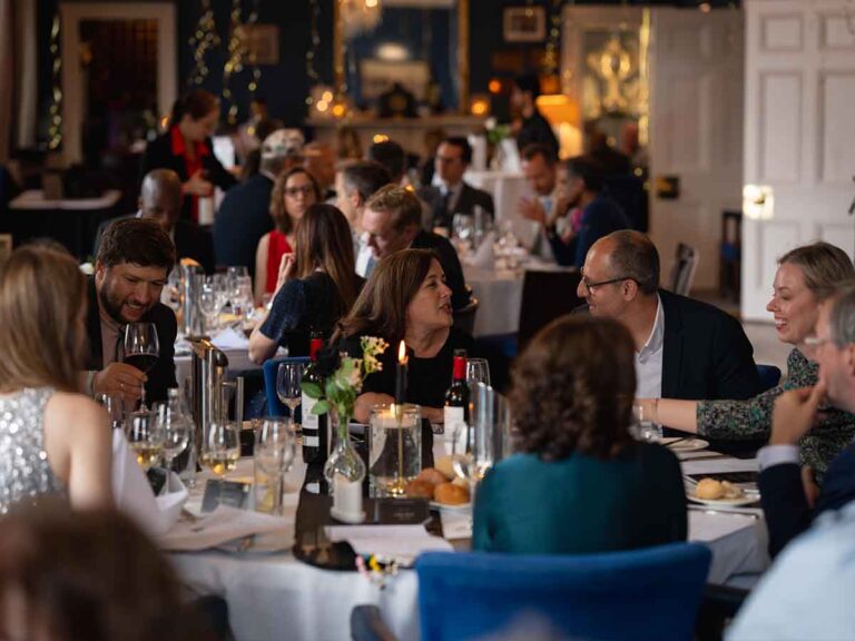 Guests seated at dinner tables during a private party at a Dublin venue