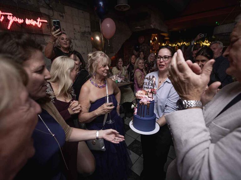 Birthday cake carried through the guests at a party in a Dublin bar